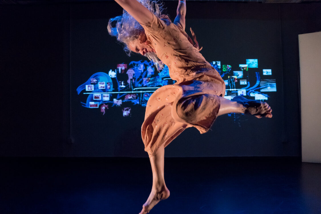 Dancer Jumping with projection in background