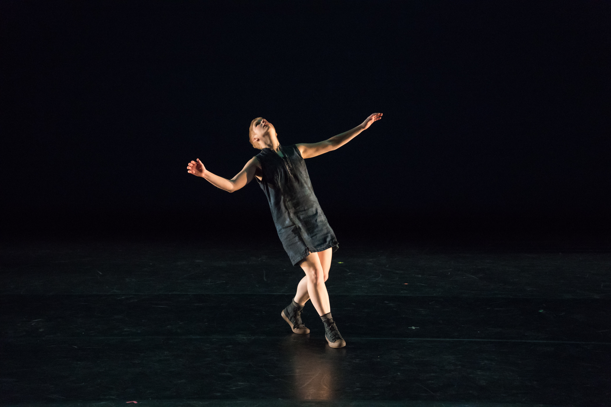 One dancer on stage, looking up