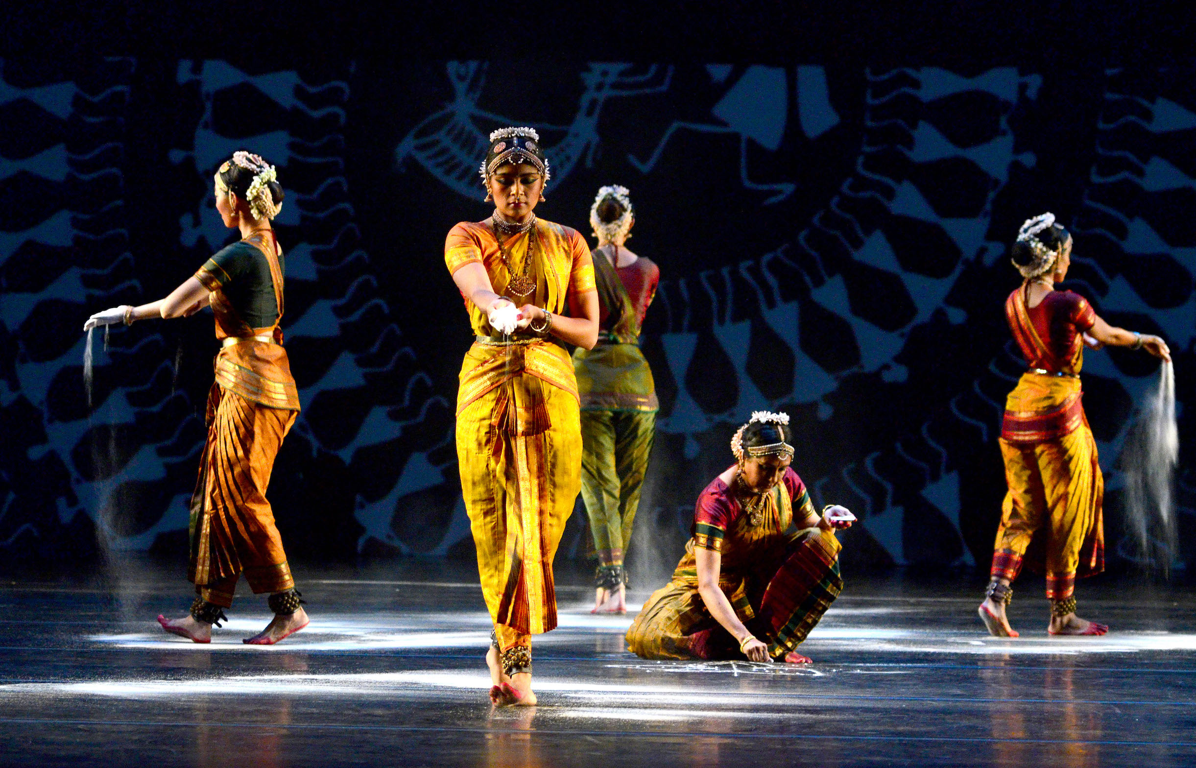 Dancers in Bharatanatyam dress drawing in salt