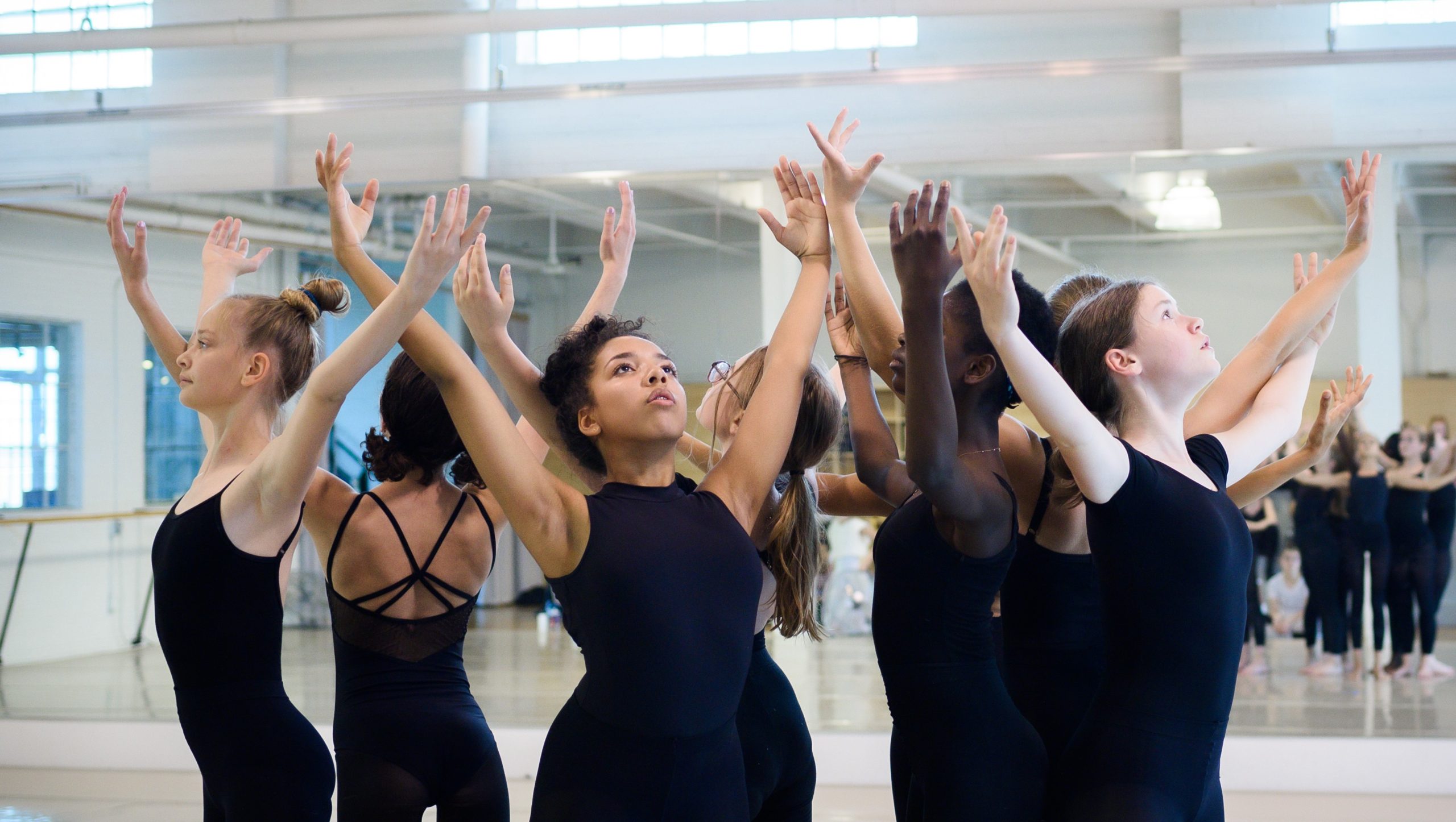 Group of young dancers, arms outstretched
