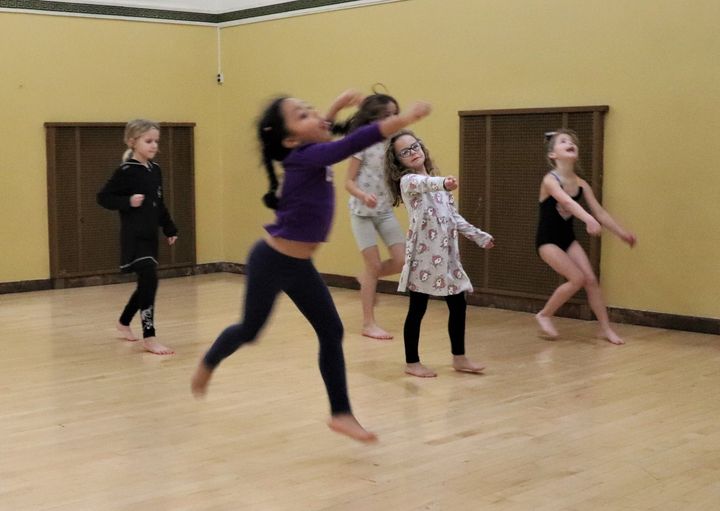 A group of children dance in a studio at the Center for Performing Arts